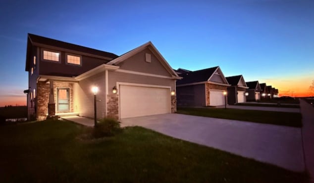 view of front of home featuring a garage and a yard