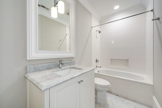 full bathroom featuring tiled shower / bath, vanity, and toilet