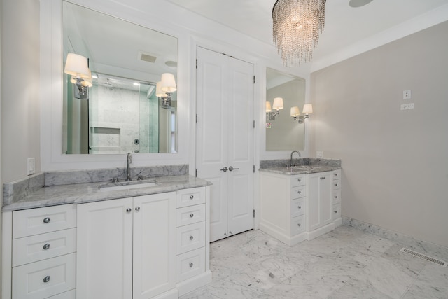 bathroom with vanity, a chandelier, and a shower with door