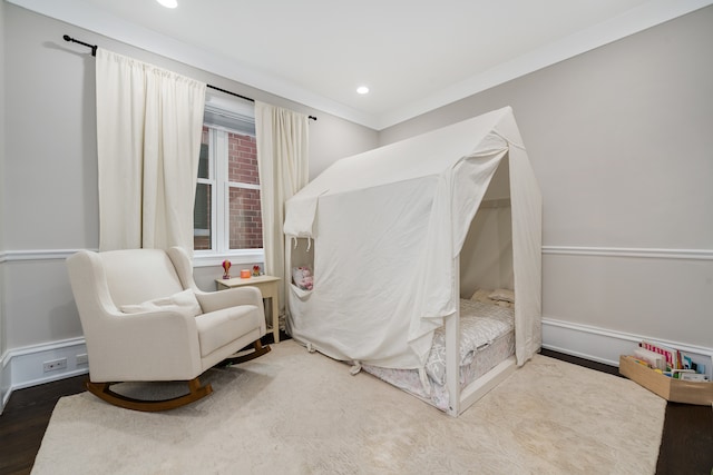 bedroom featuring crown molding and wood-type flooring