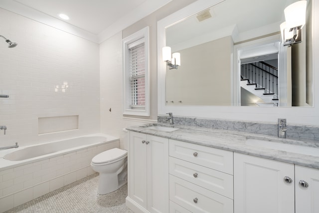 full bathroom featuring tiled shower / bath, vanity, toilet, and tile patterned floors