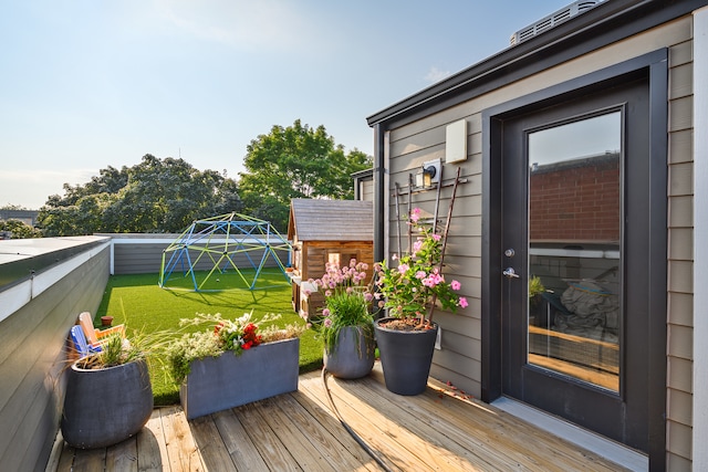 wooden deck featuring a yard