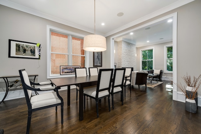 dining room with ornamental molding and dark hardwood / wood-style floors