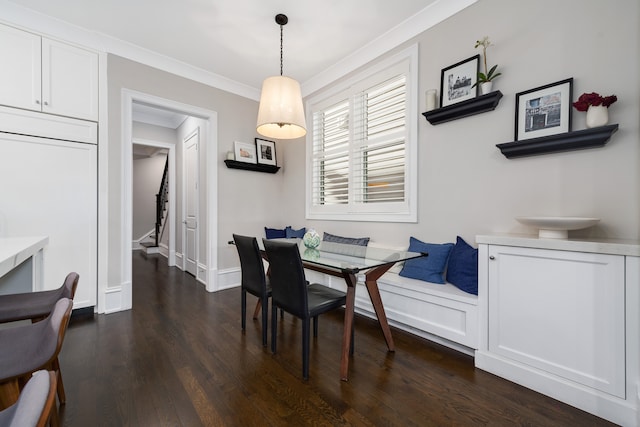 dining room featuring ornamental molding and dark hardwood / wood-style floors