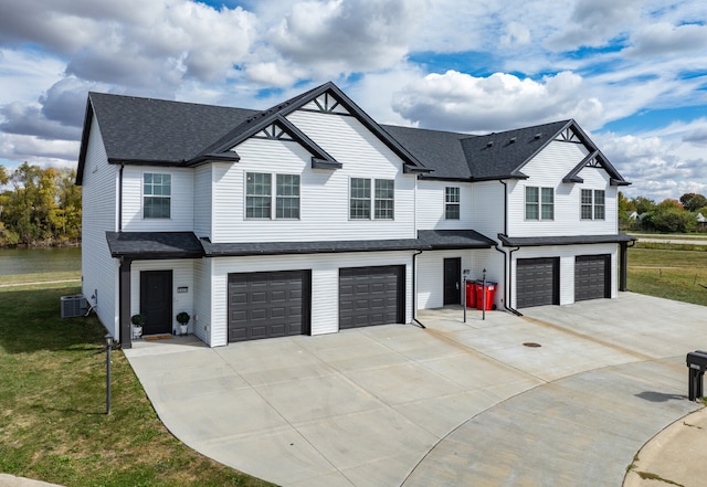 view of front of home featuring a front yard, a garage, and cooling unit