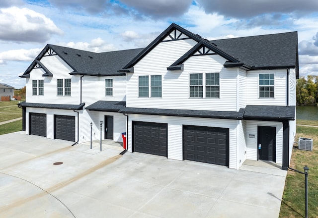 view of front of property with cooling unit and a garage