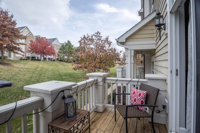 wooden terrace featuring a yard