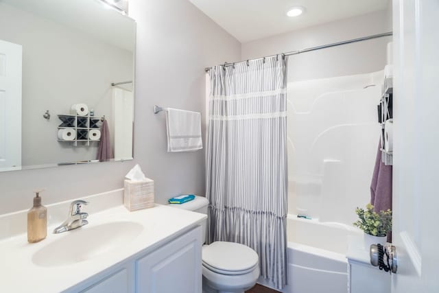 full bathroom featuring vanity, shower / bath combo, and toilet