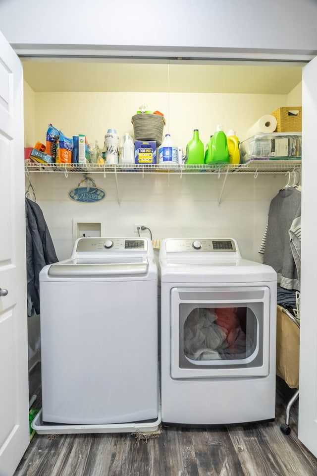 clothes washing area with separate washer and dryer and dark hardwood / wood-style floors