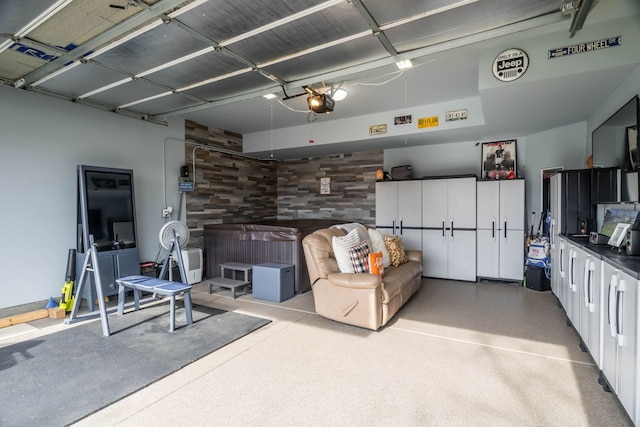 garage with a garage door opener and wood walls