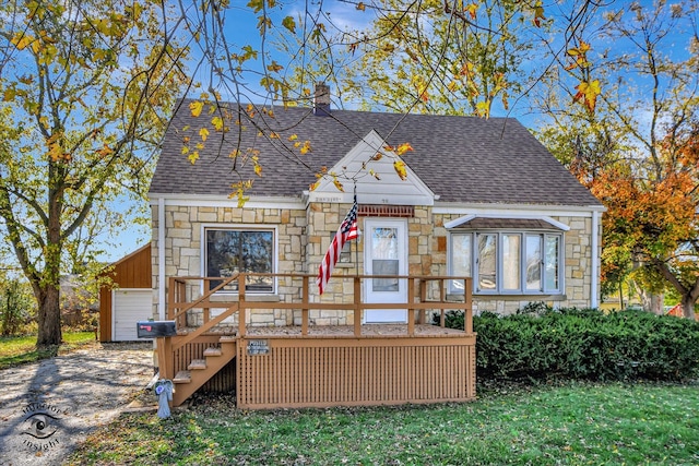 exterior space featuring a garage and a wooden deck