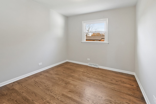 empty room with hardwood / wood-style floors