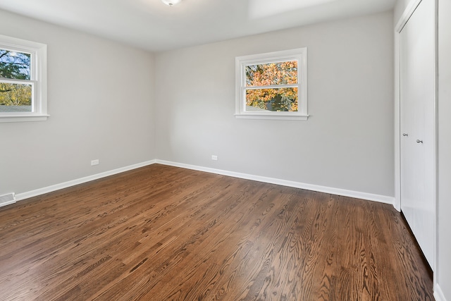 unfurnished bedroom featuring dark hardwood / wood-style floors