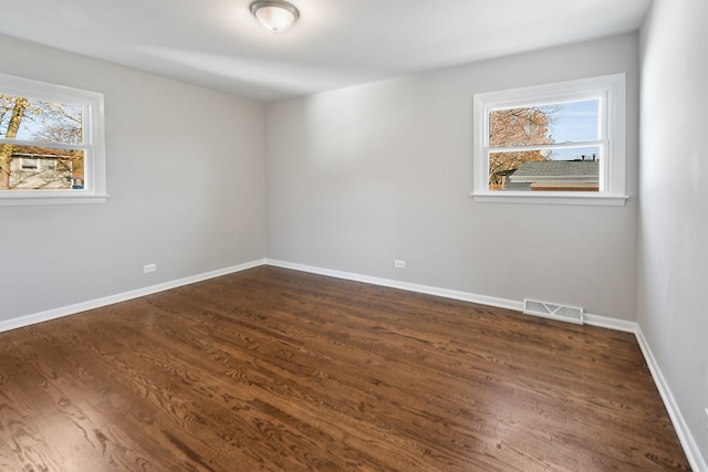 spare room featuring dark hardwood / wood-style flooring