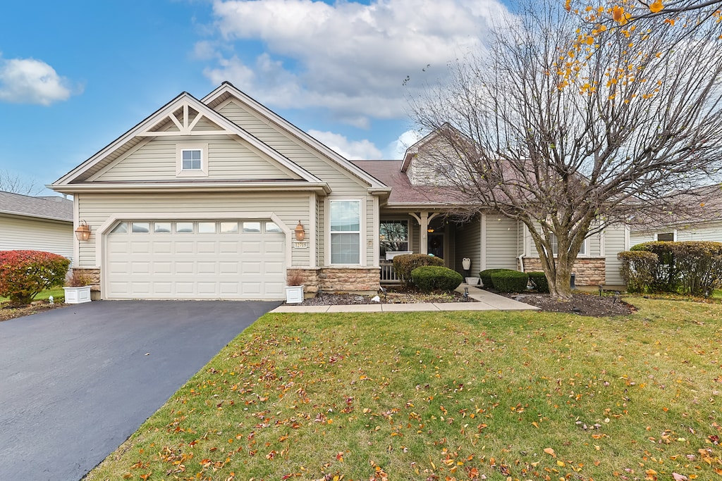 view of front of house featuring a front yard and a garage