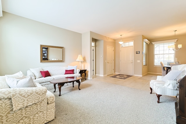 living room featuring light carpet and an inviting chandelier