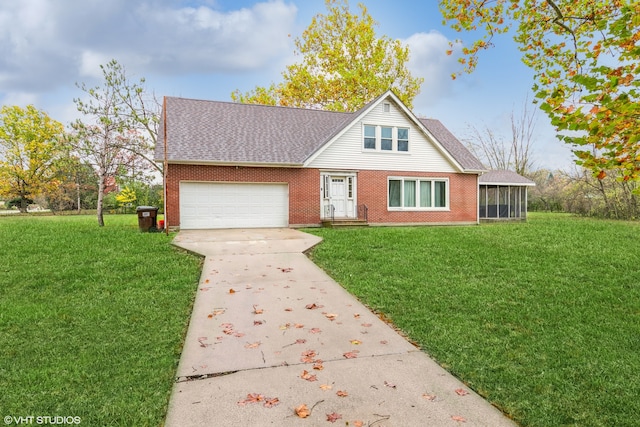 view of front of home with a garage, a front yard, and a sunroom