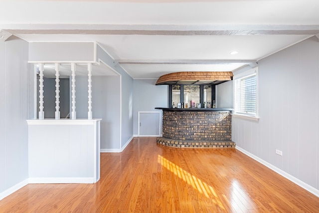 bar with beamed ceiling and wood-type flooring