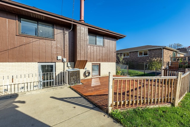 rear view of property with a patio, cooling unit, and a deck