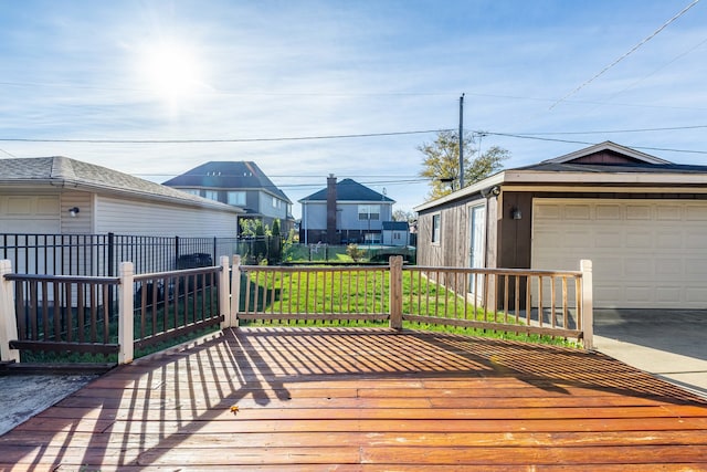 wooden terrace featuring a garage and a yard