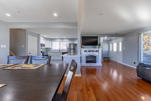 dining space featuring sink, a wealth of natural light, and wood-type flooring