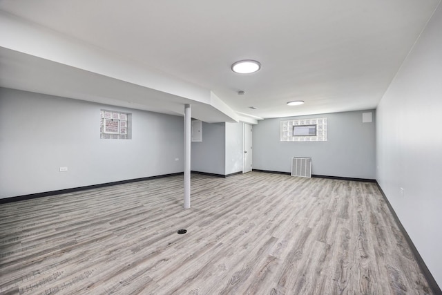 basement with a healthy amount of sunlight and light wood-type flooring