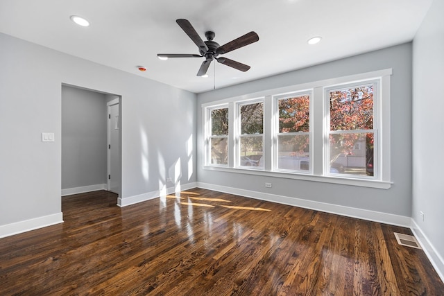 empty room featuring ceiling fan and dark hardwood / wood-style flooring