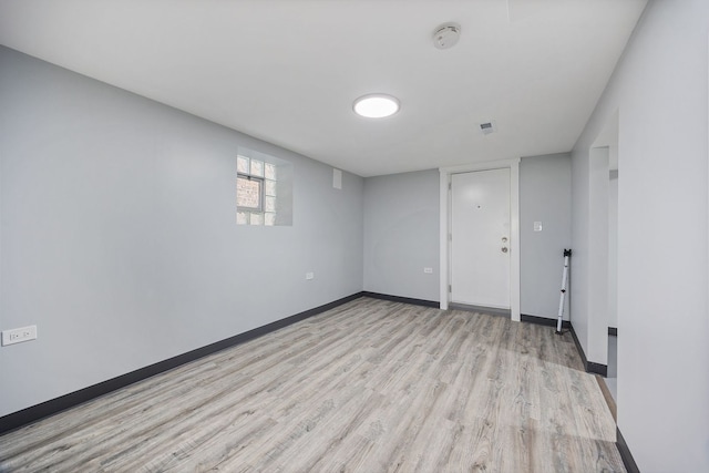 spare room with light hardwood / wood-style flooring