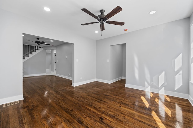 unfurnished living room featuring ceiling fan and dark hardwood / wood-style flooring