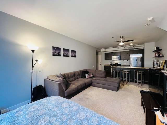 living room featuring ceiling fan and light colored carpet