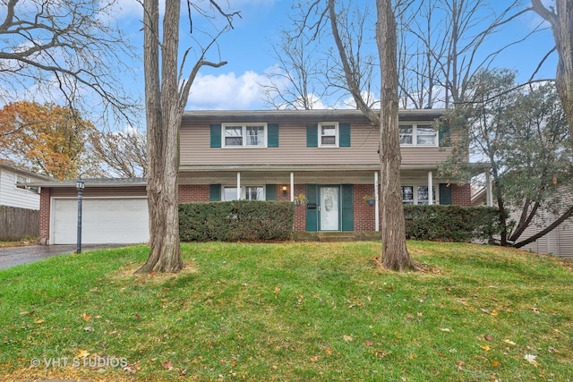 view of front of property featuring a garage and a front yard