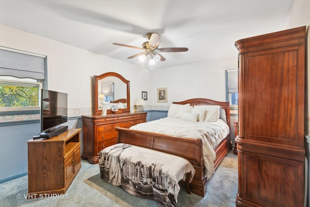 bedroom featuring light colored carpet and ceiling fan