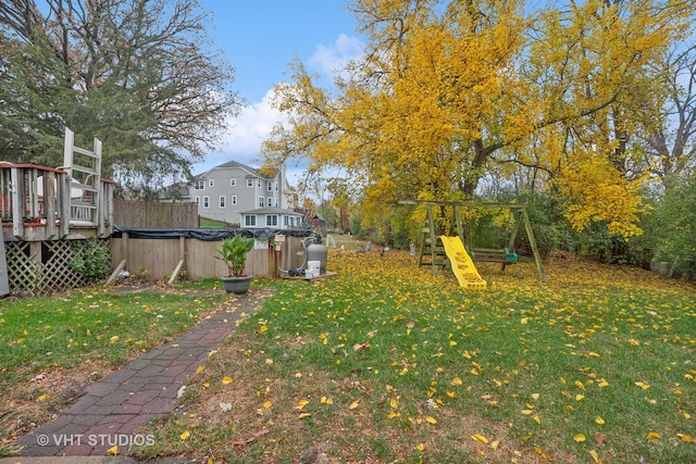 view of yard featuring a playground and a wooden deck