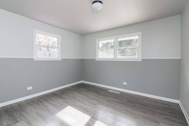 empty room with hardwood / wood-style flooring