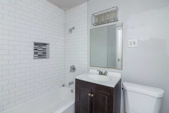 full bathroom with toilet, tiled shower / bath, and vanity