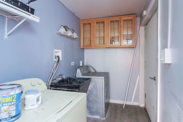 laundry area with independent washer and dryer and dark hardwood / wood-style floors