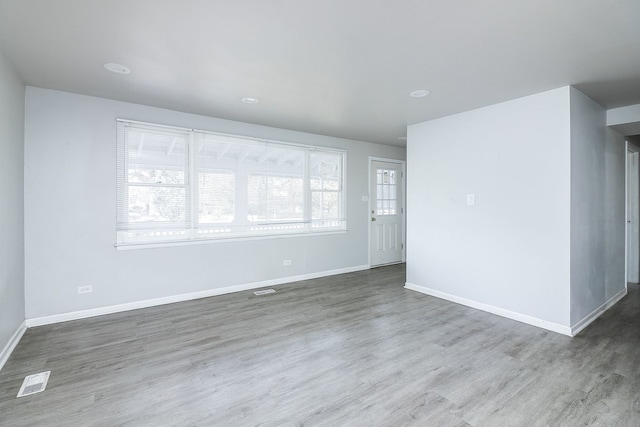 empty room featuring hardwood / wood-style floors and a healthy amount of sunlight