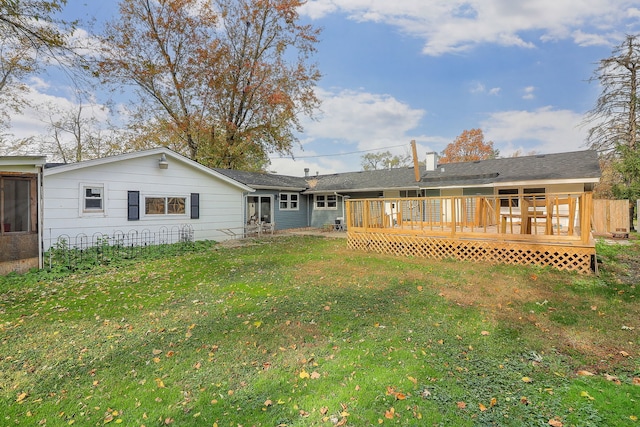 back of property featuring a yard and a deck