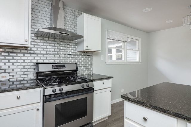 kitchen with decorative backsplash, dark hardwood / wood-style floors, wall chimney exhaust hood, white cabinetry, and gas stove