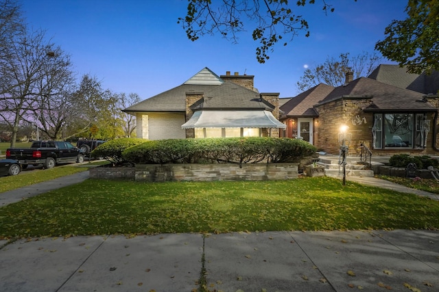 bungalow-style house with a lawn