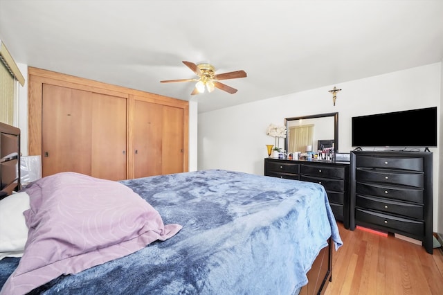 bedroom with light hardwood / wood-style flooring and ceiling fan