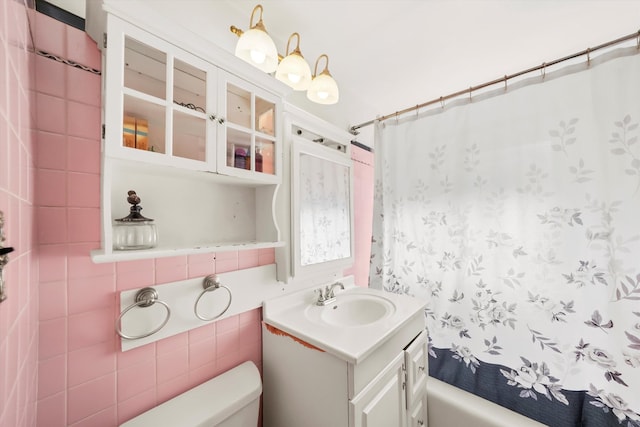 full bathroom with vanity, shower / bath combo with shower curtain, and toilet