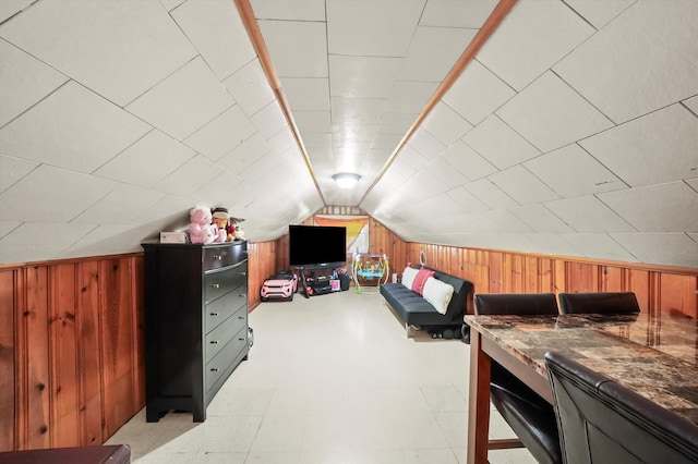 bonus room featuring wood walls and vaulted ceiling