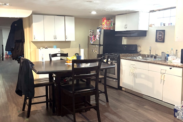 kitchen featuring stainless steel gas range oven, white cabinets, sink, and dark hardwood / wood-style flooring