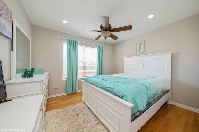 bedroom with ceiling fan and light hardwood / wood-style flooring