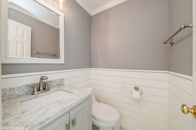 bathroom with vanity, crown molding, and toilet