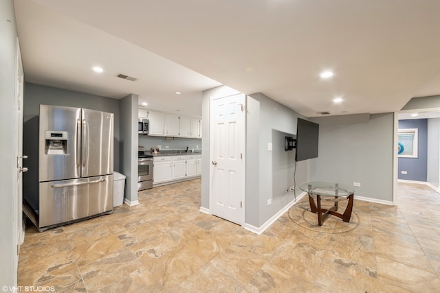 kitchen with sink, appliances with stainless steel finishes, and white cabinets