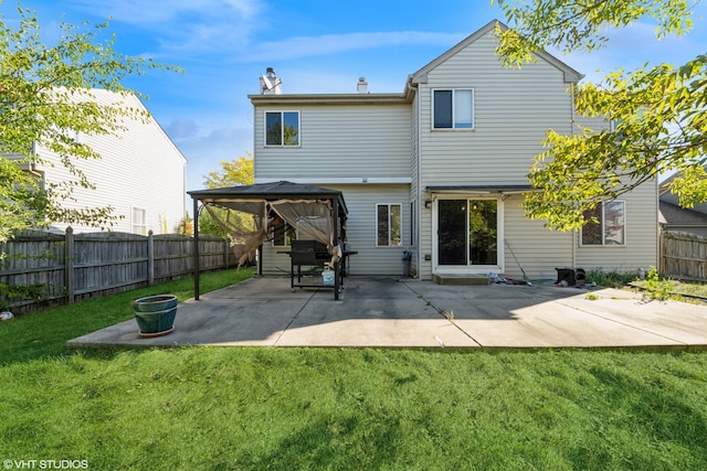 rear view of house featuring a patio, a gazebo, and a lawn