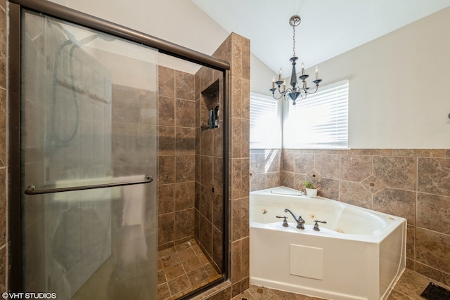 bathroom with tile walls, vaulted ceiling, shower with separate bathtub, and a notable chandelier