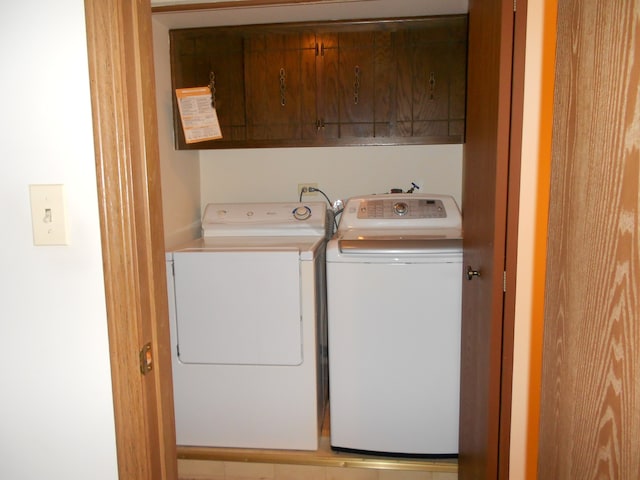 laundry room featuring cabinets and washer and dryer